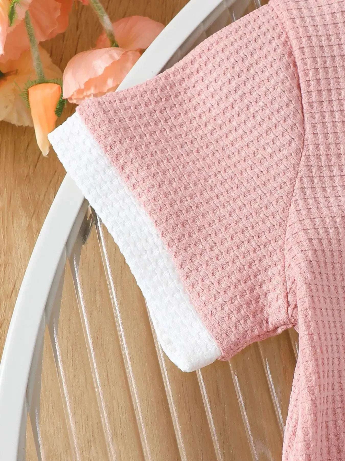 Pink waffle-knit long-sleeve tee with white collar trim