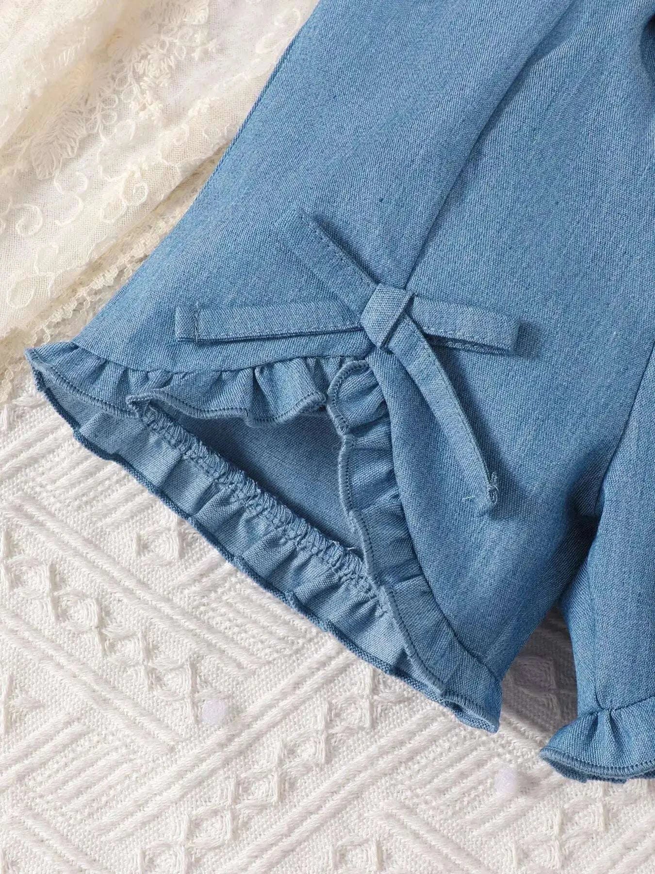 Blue ruffle-hem shorts with side bow ties and gathered skirt-like panel