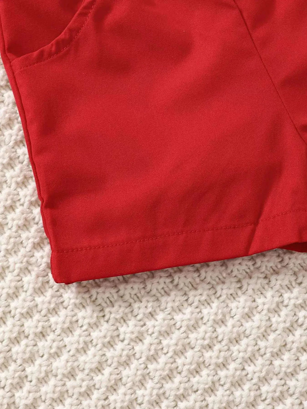 Red kids shorts with stitched hem and pocket panel detail