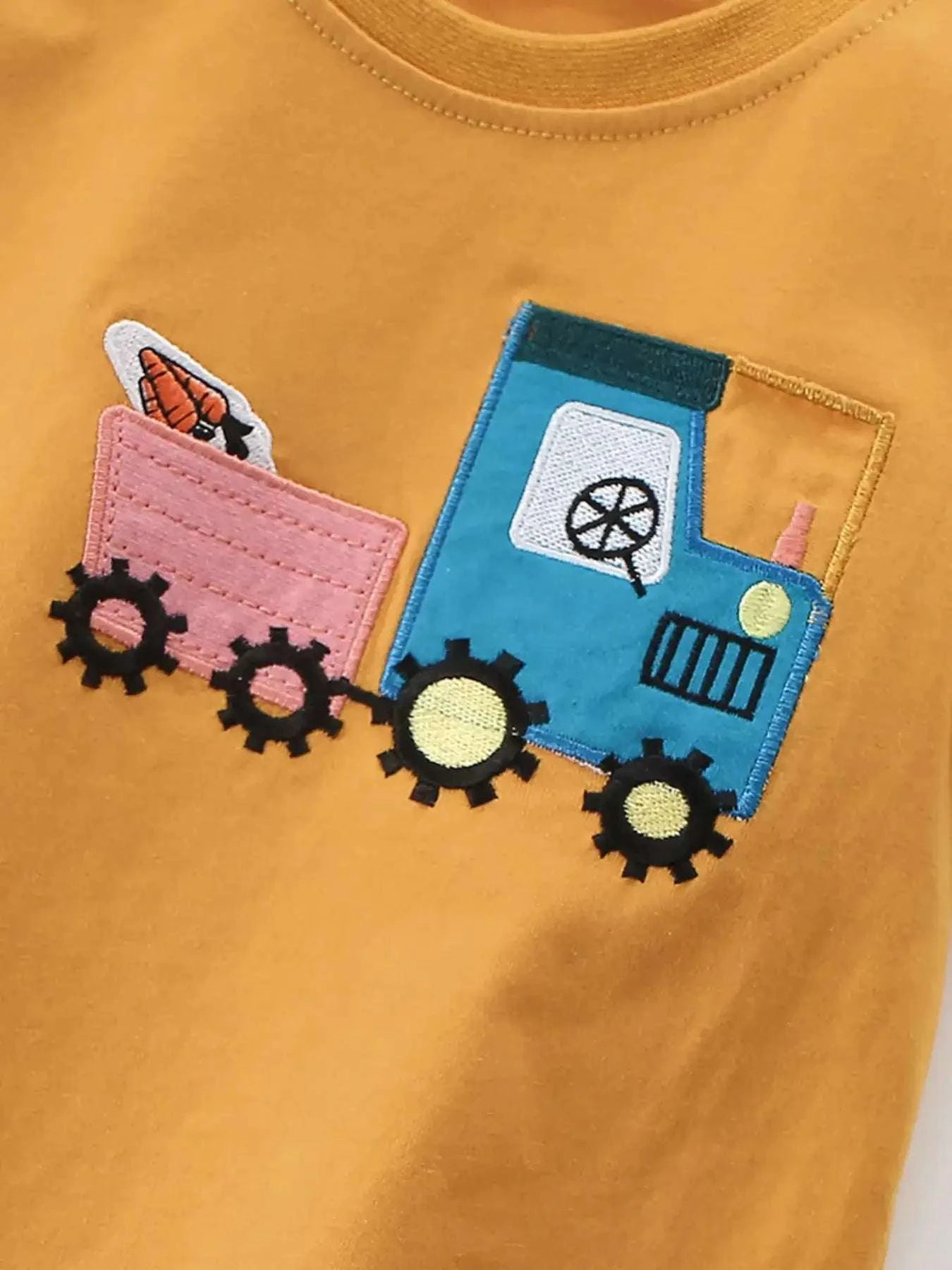 Children's gold t-shirt with colorful cartoon truck graphic on front