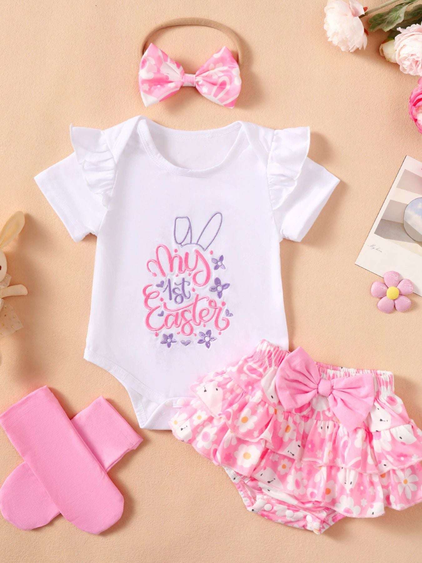 White bodysuit with pink bunny embroidery, pink ruffle skirt, headband bow, and socks