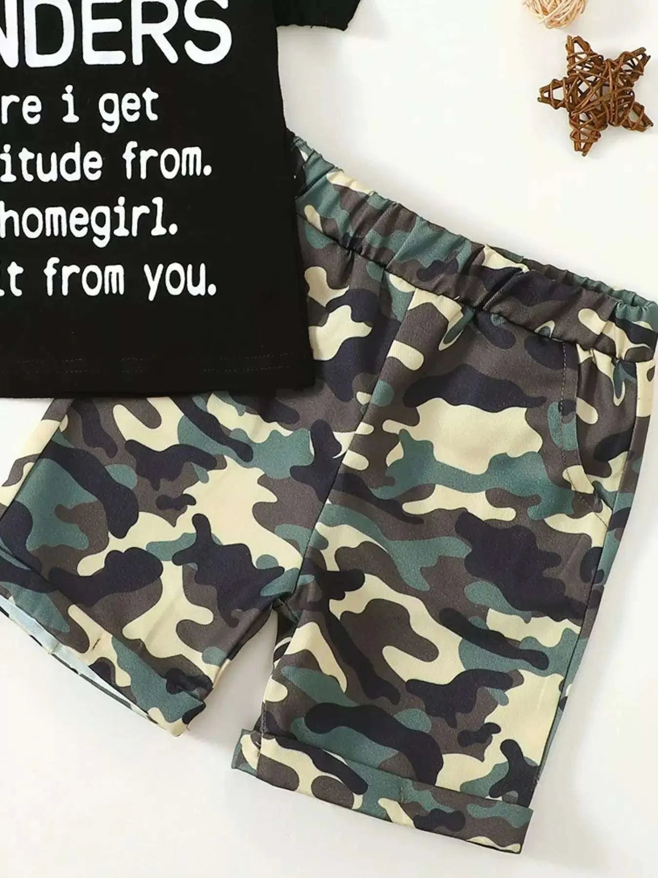 Camo shorts with elastic waist and black graphic tee with partial white text