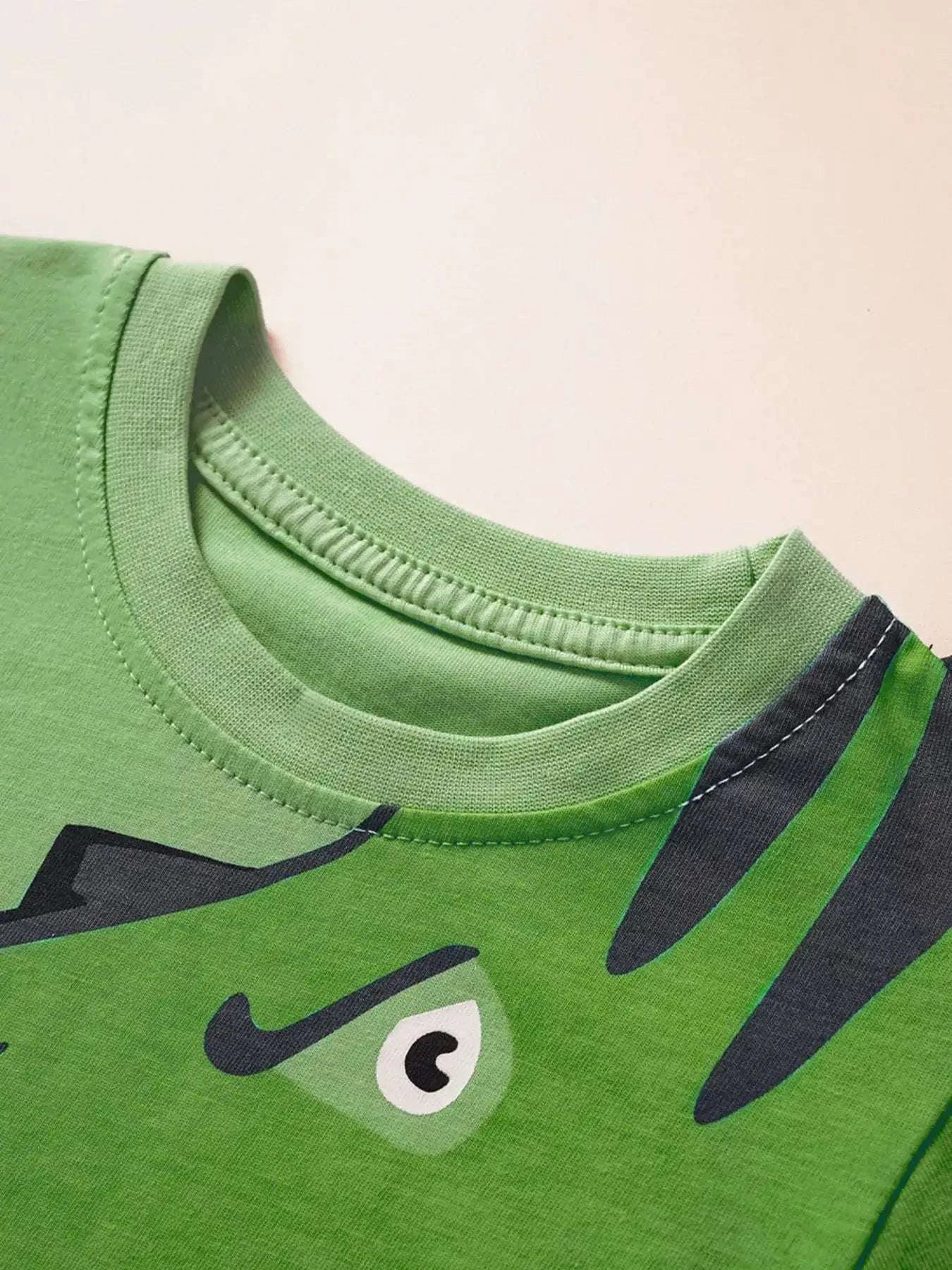 Green kids' dinosaur graphic tee, crew neck and partial face print