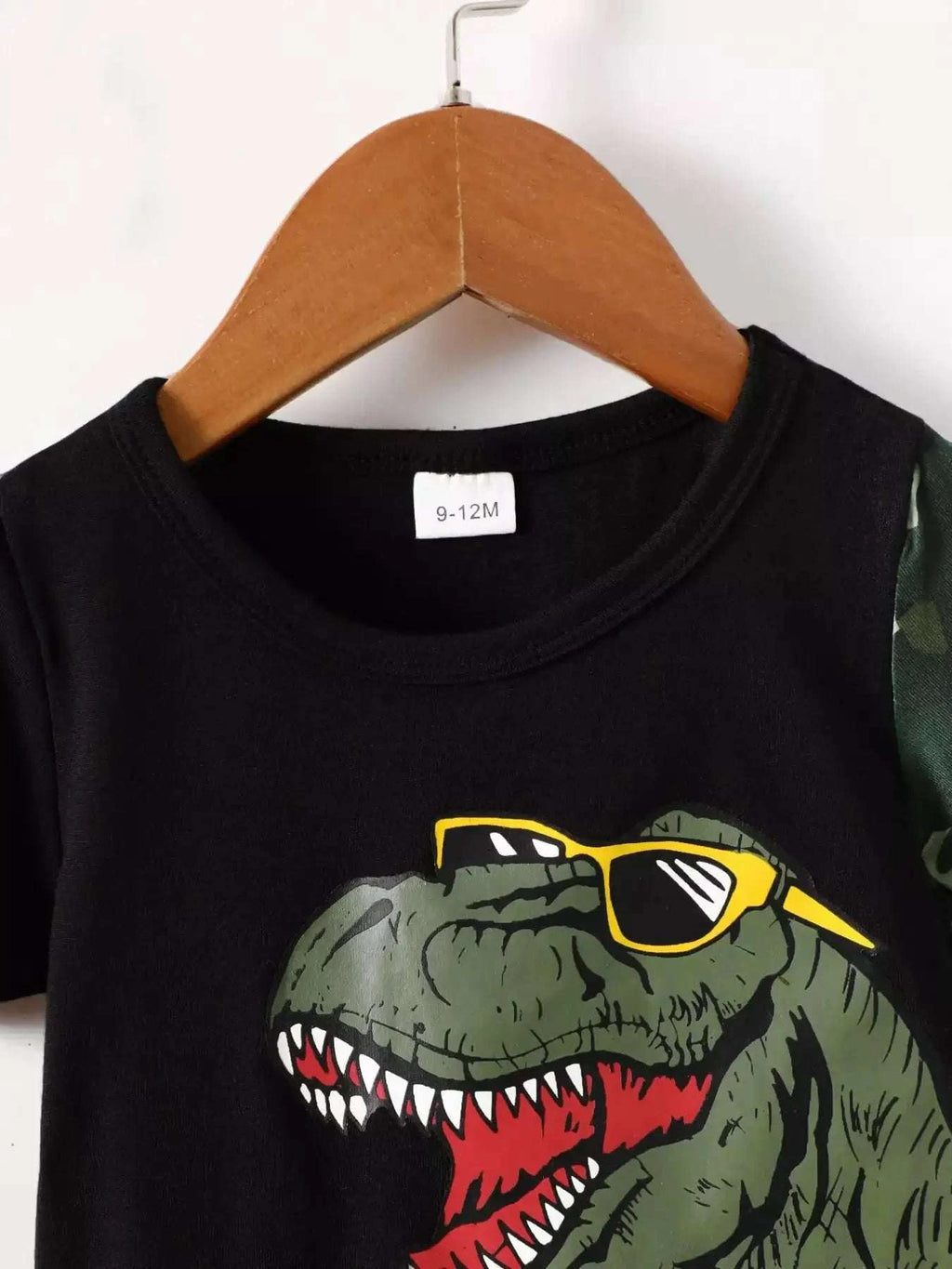 Black kids' dinosaur graphic crew-neck tee with yellow sunglasses, size tag visible