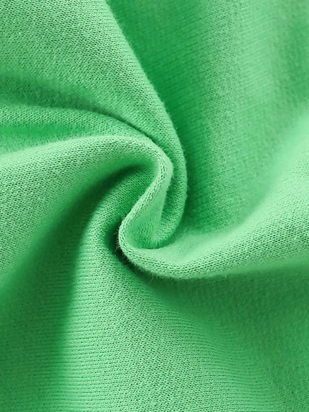 Green kids shorts close-up of soft knit fabric fold
