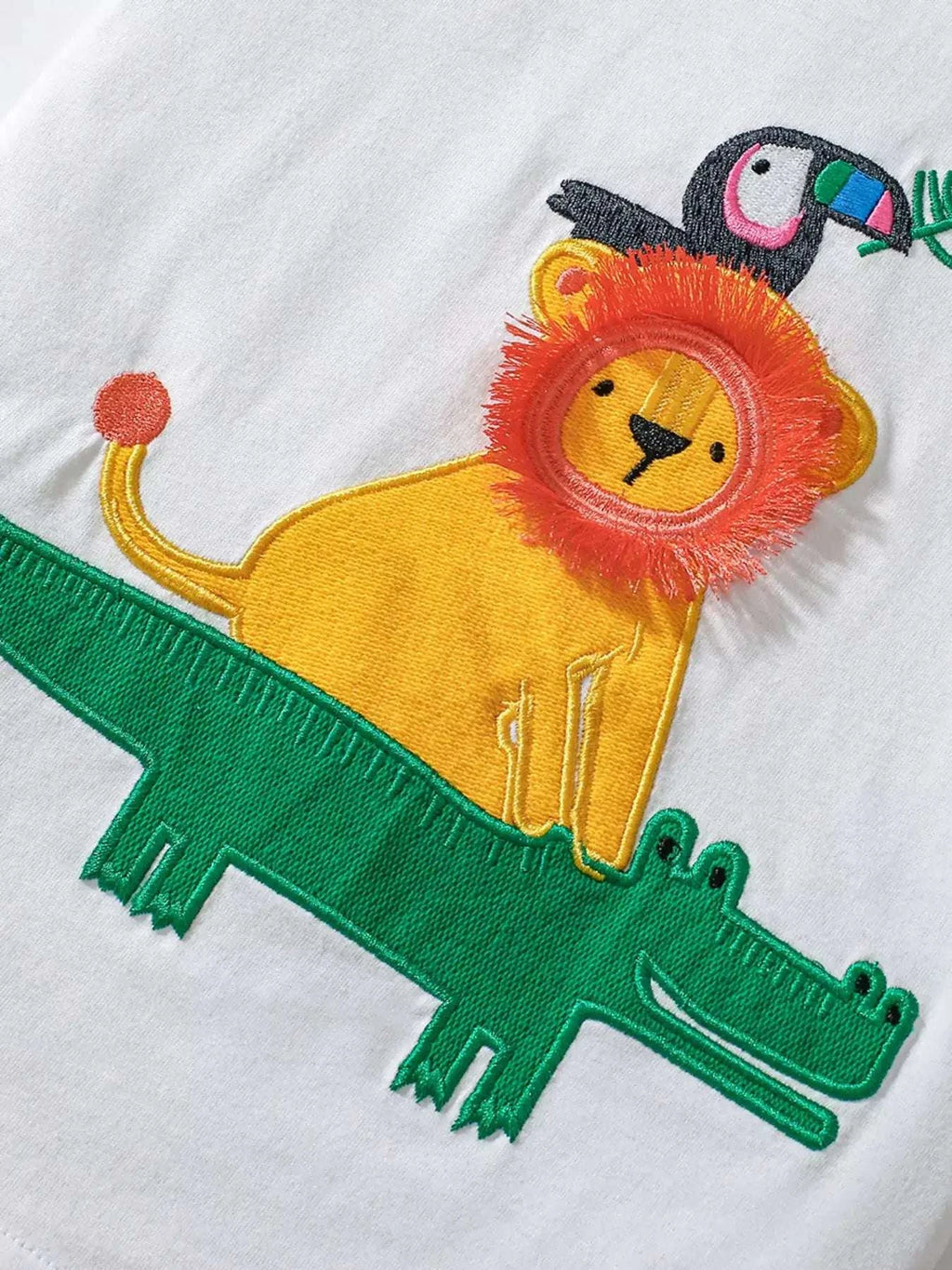 White kids T-shirt with colorful lion-like animal graphic and green applique
