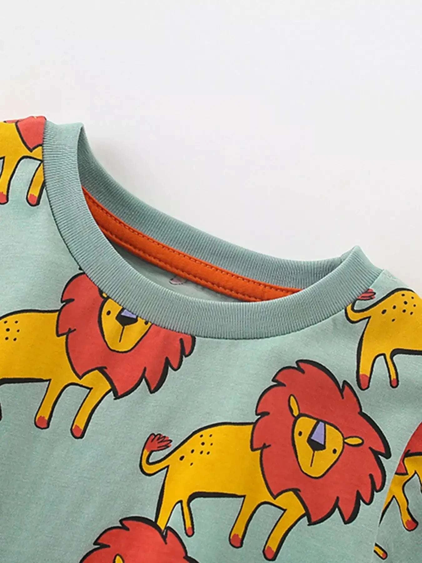 Sage green round-neck tee with lion print and orange collar trim
