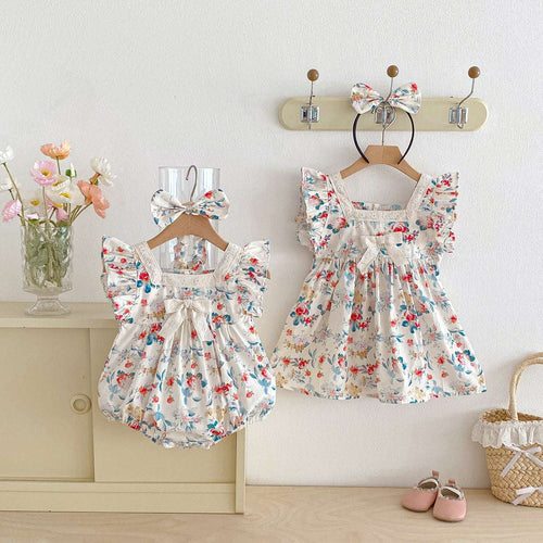 White floral ruffle-sleeve baby dress romper with bow at front and gathered skirt