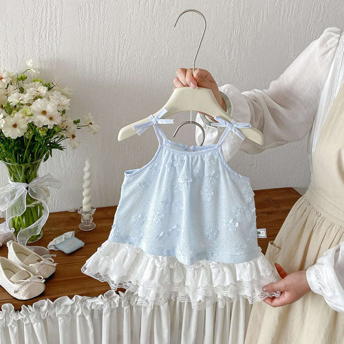 Light blue sleeveless dress on hanger with white tiered lace ruffle skirt