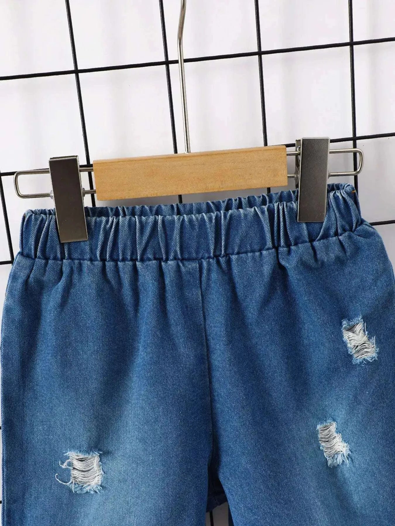 Blue denim shorts with elastic waistband and frayed ripped patches