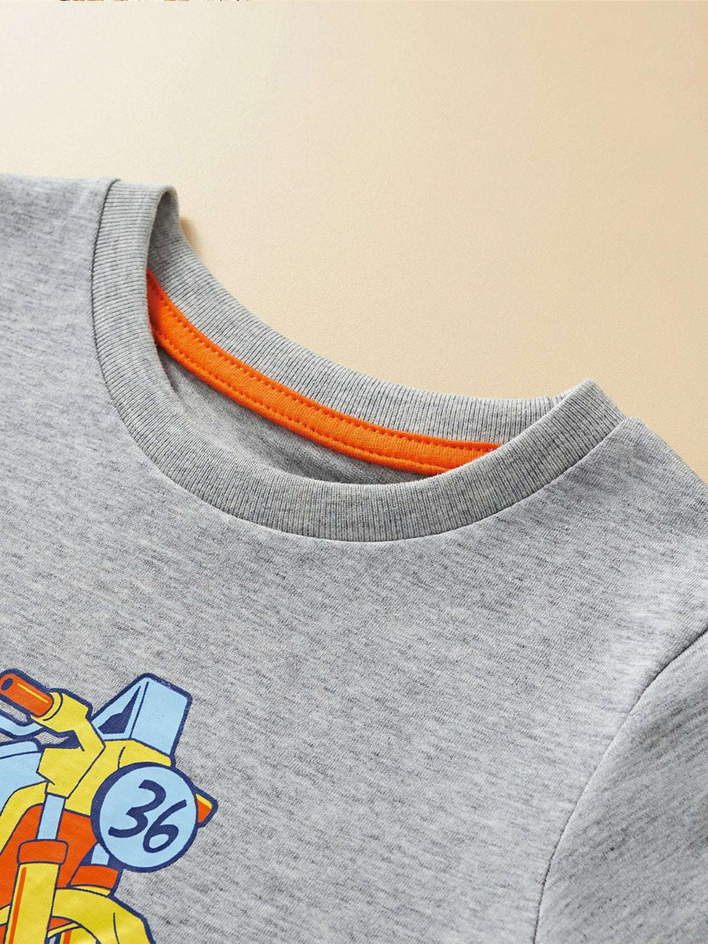 Light gray crew-neck T-shirt with orange ribbed collar and partial vehicle graphic