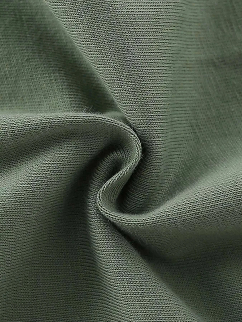 Dark green kids graphic tee fabric close-up, knit cotton texture