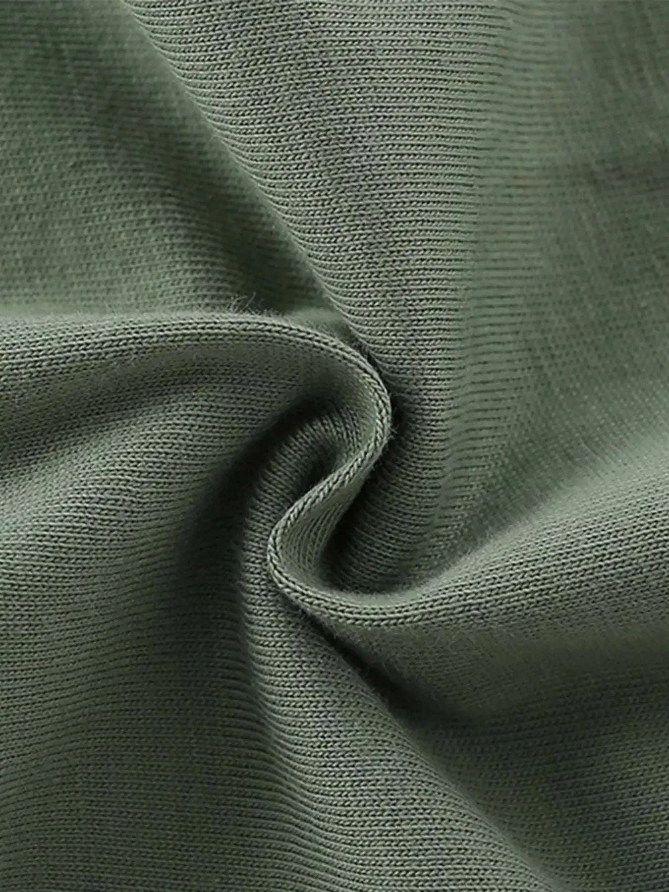 Dark green kids graphic tee fabric close-up, knit cotton texture