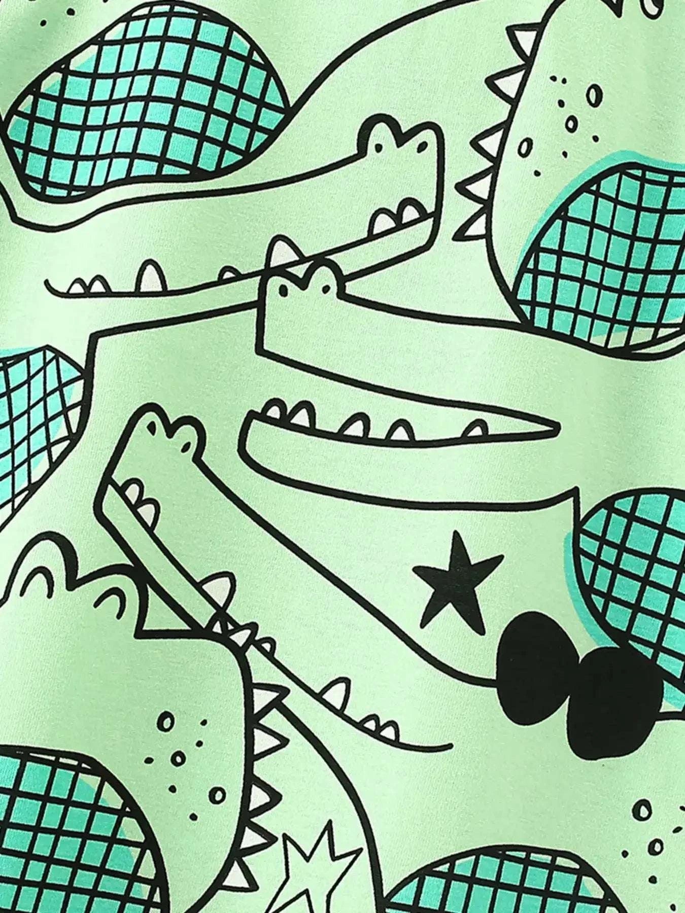 Mint green crocodile print kids T-shirt fabric close-up with teal scale pattern