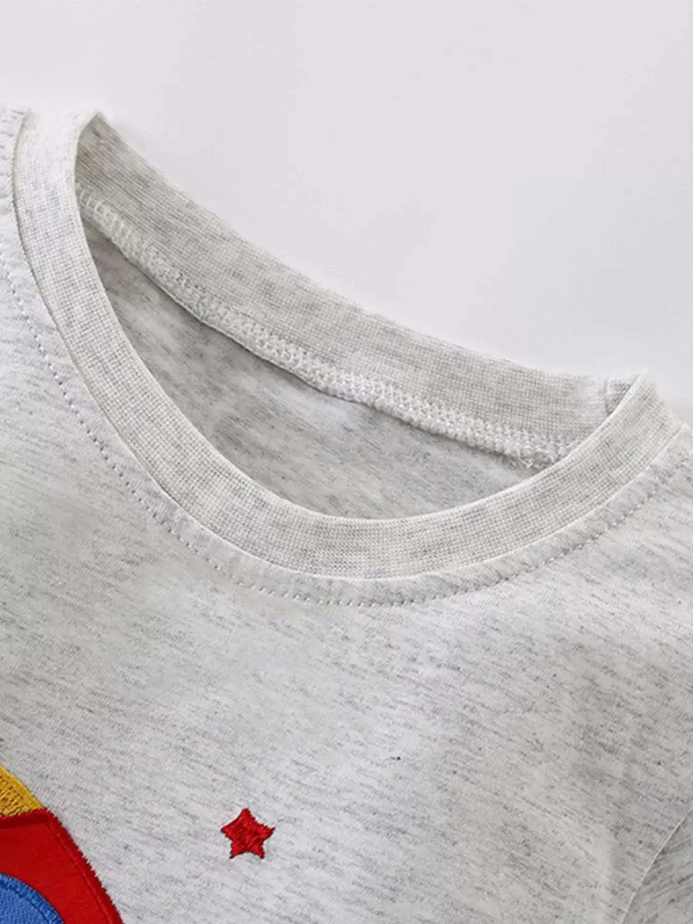 Light gray kids T-shirt neckline with small red star applique