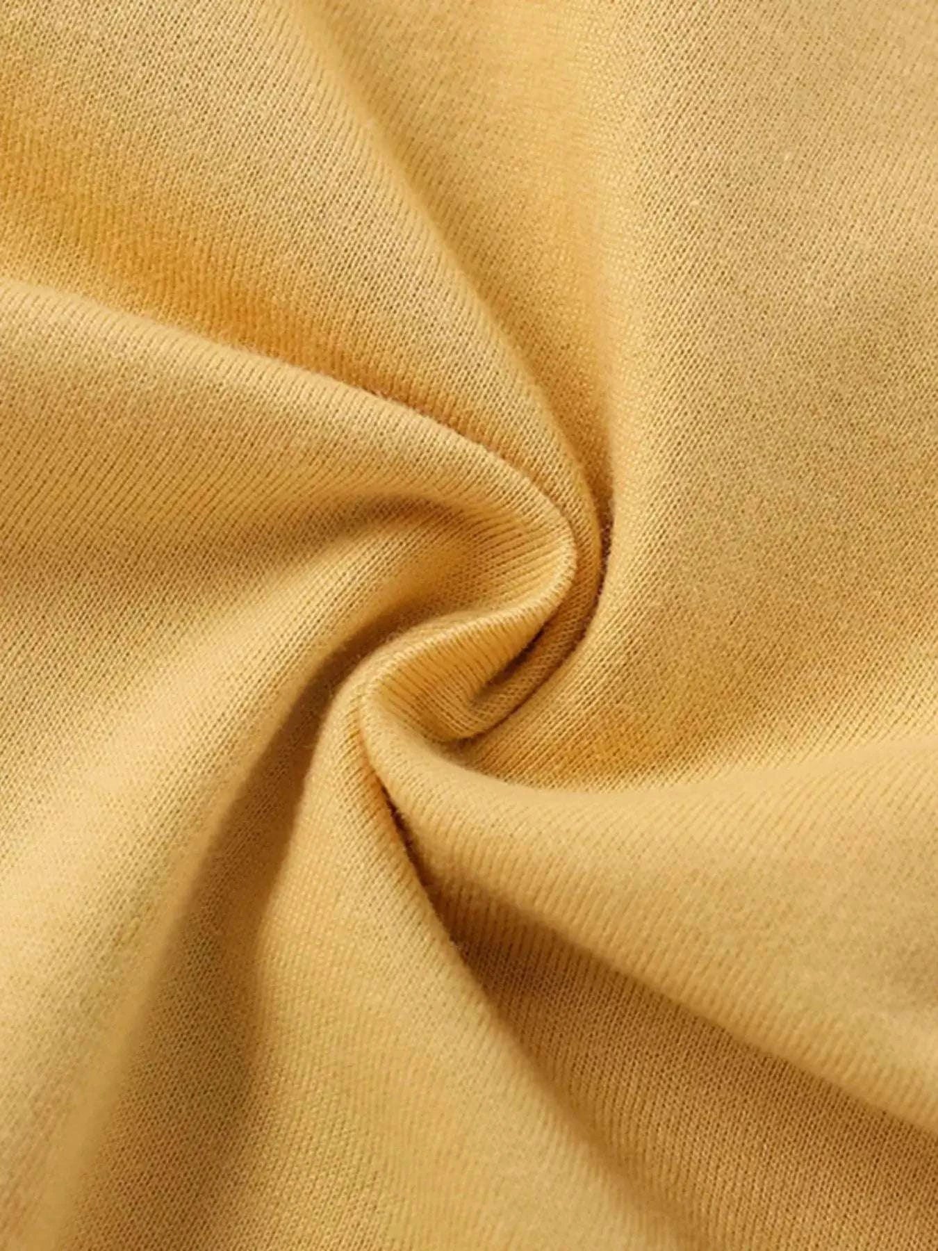 Gold kids T-shirt fabric close-up with soft knit texture