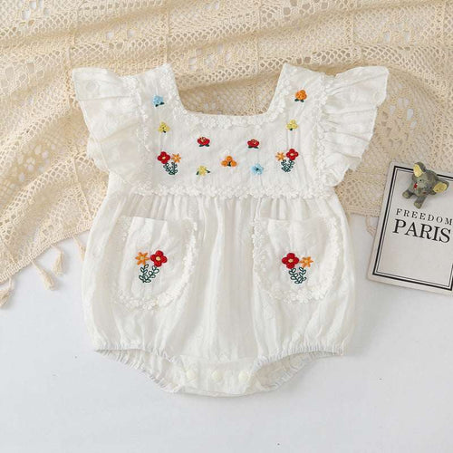 White baby romper with flower embroidery, flutter sleeves, and embroidered patch pockets