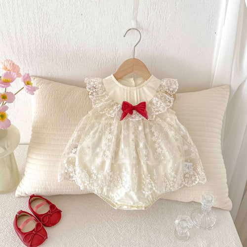 Apricot lace baby romper with ruffled shoulders, red bow, and layered tulle skirt