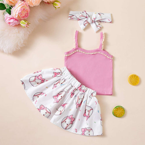 Girls pink tank top with baseball graphic, white bow skirt, and hair bow headband