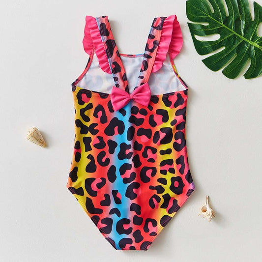 Kids one-piece swimsuit, colorful leopard print with pink bow at center