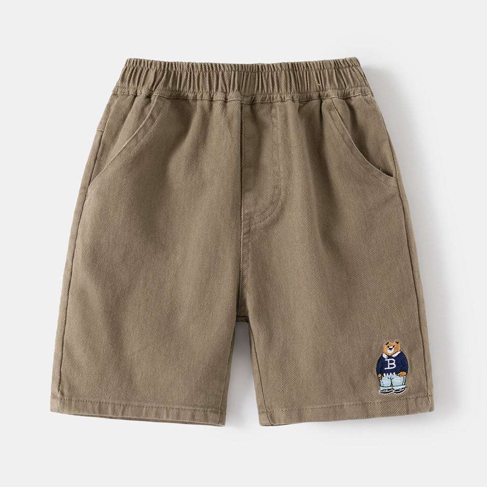 Tan boys casual shorts with elastic waistband and cartoon patch embroidery near right hem