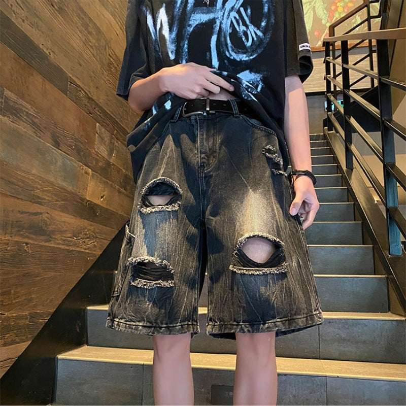 Boys ripped denim shorts, loose dark blue wash, large distressed cutouts at front