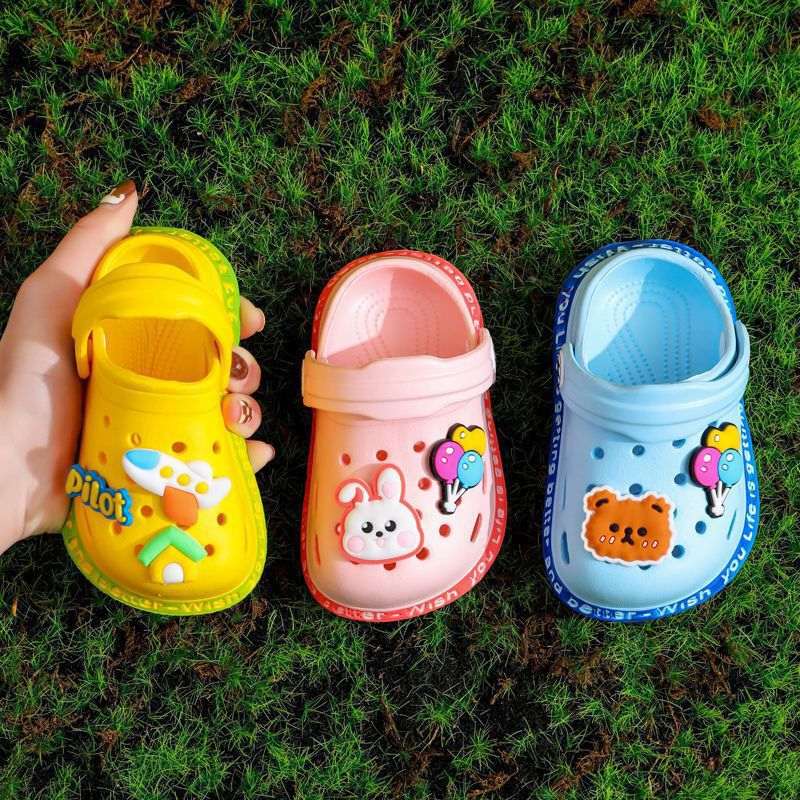Kids’ colorful slip-on clogs in yellow, pink, and blue with animal prints
