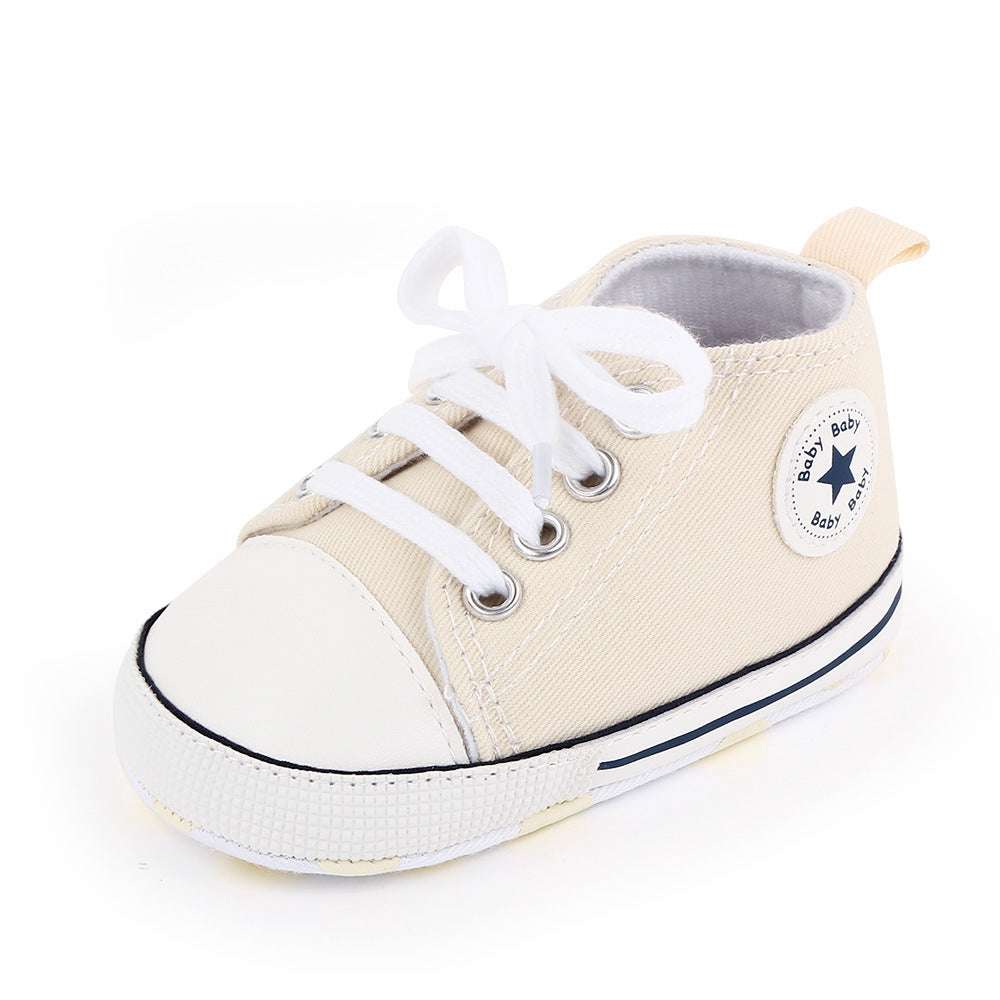 Cream canvas baby high-top shoes with white laces and star badge patch
