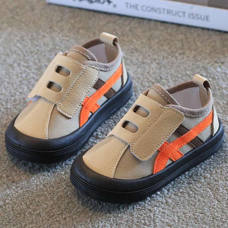 Kids canvas sneakers in tan with orange side stripe and Velcro hook-and-loop tabs