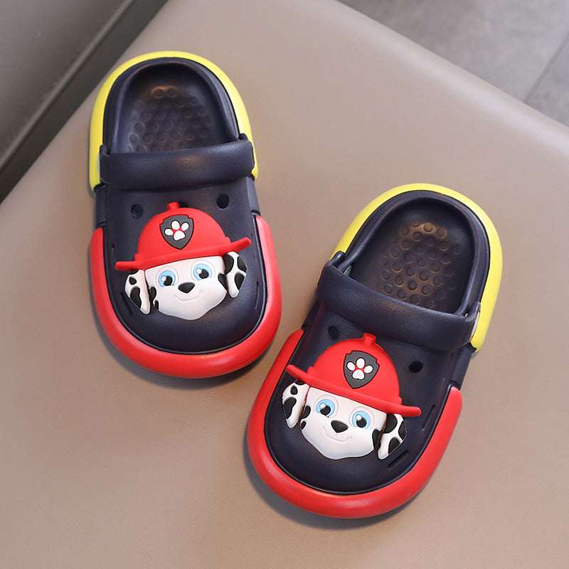 Kids' croc-style Paw Patrol slippers, navy with red soles and yellow trim, dog face.