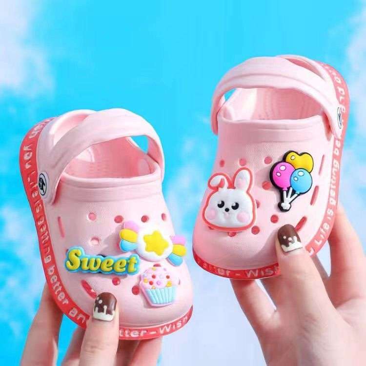 Pink kids' cartoon clogs with bunny, bird, and cupcake patches on the top