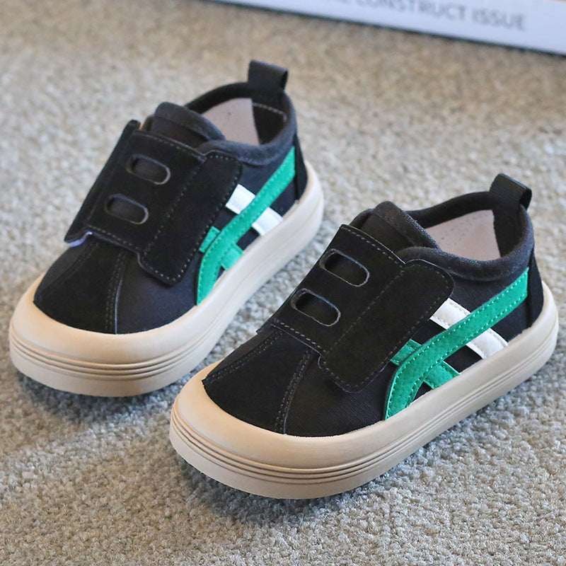 Kids canvas sneakers in black with green side stripe and Velcro closure