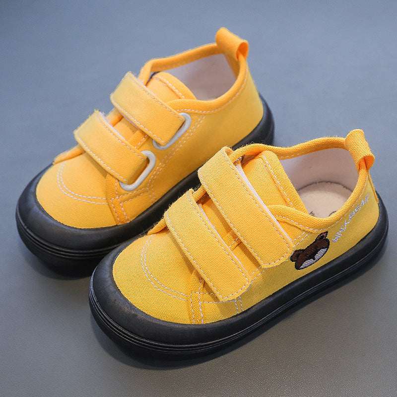 Kids canvas sneakers in yellow with Velcro straps and black rubber sole