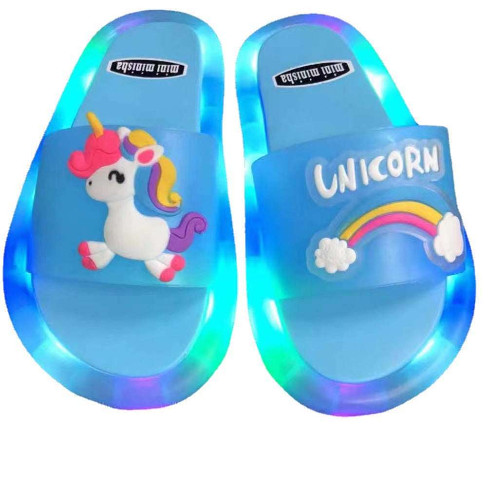 Light-up kids unicorn sandals, blue translucent upper with white UNICORN text
