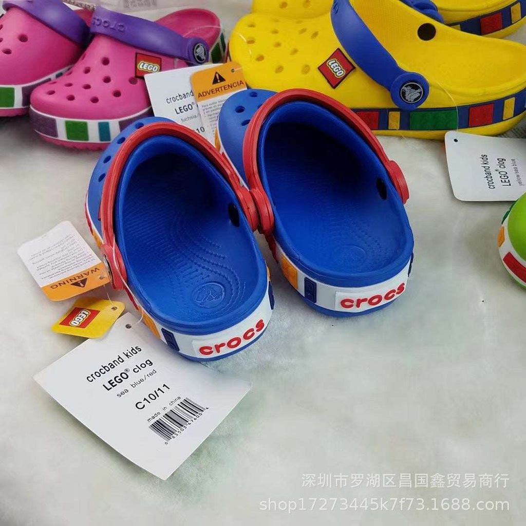 Kids blue perforated clogs sandals with red trim, white sole, side strap logo