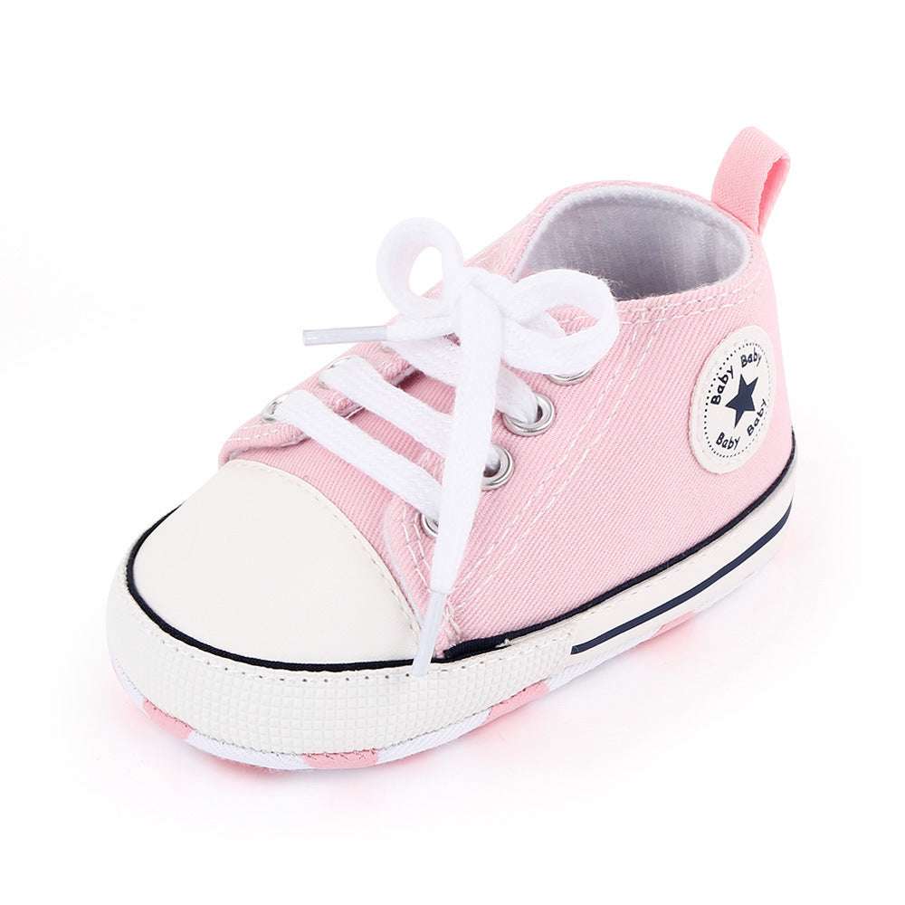 Pink canvas baby high-top shoes with white laces and star badge patch