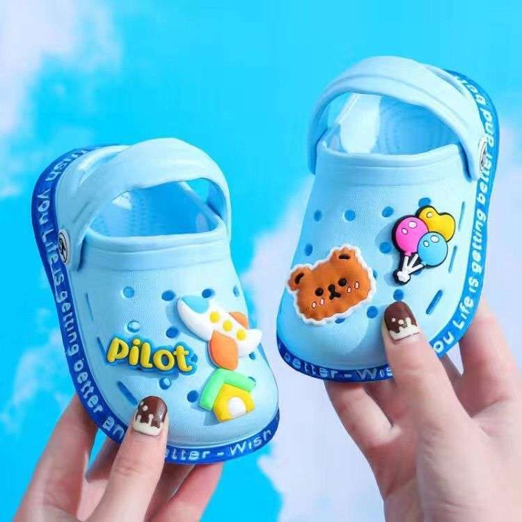 Light blue kids' slip-on clogs with cartoon patches and ventilation holes