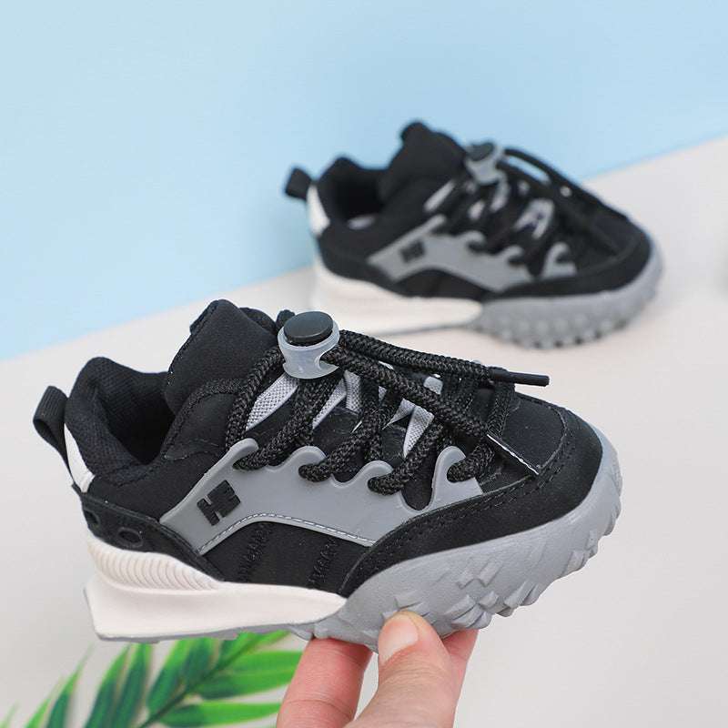 Kids chunky sneakers in black with gray accents and white tread sole, lace-up.