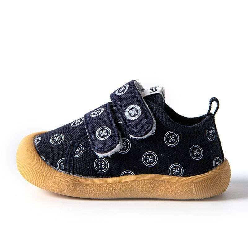 Navy baby cloth shoes with smiley pattern, tan non-slip sole, teal pull tab