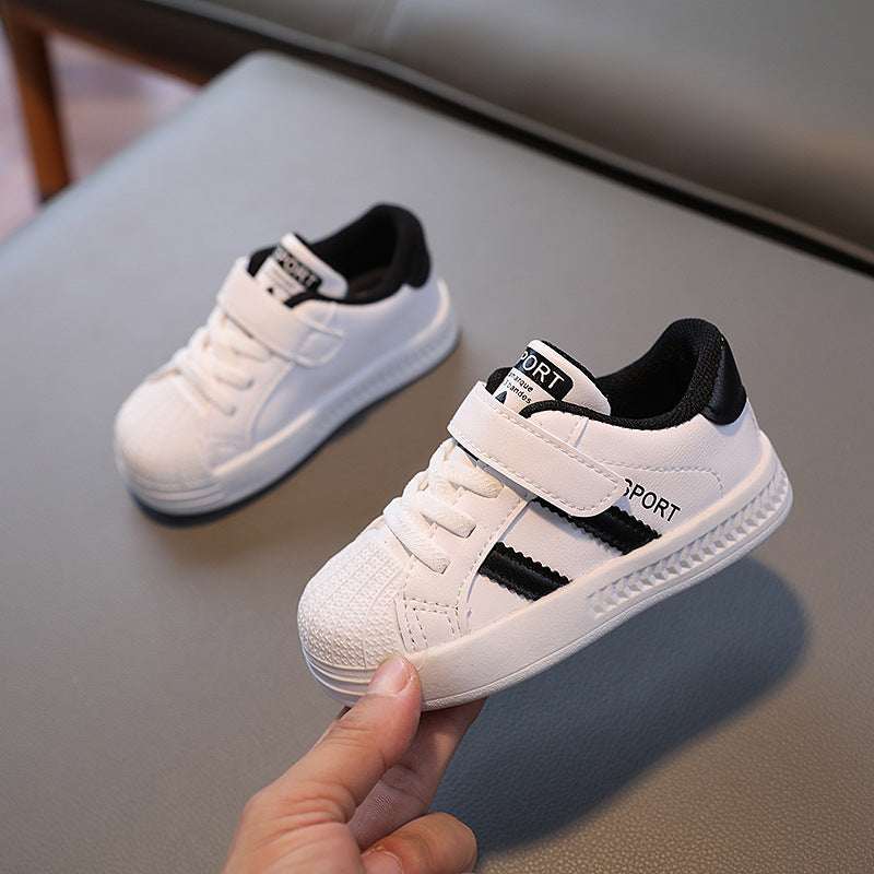 Kids low-top sneakers, white with black trim, side stripe and hook-and-loop strap