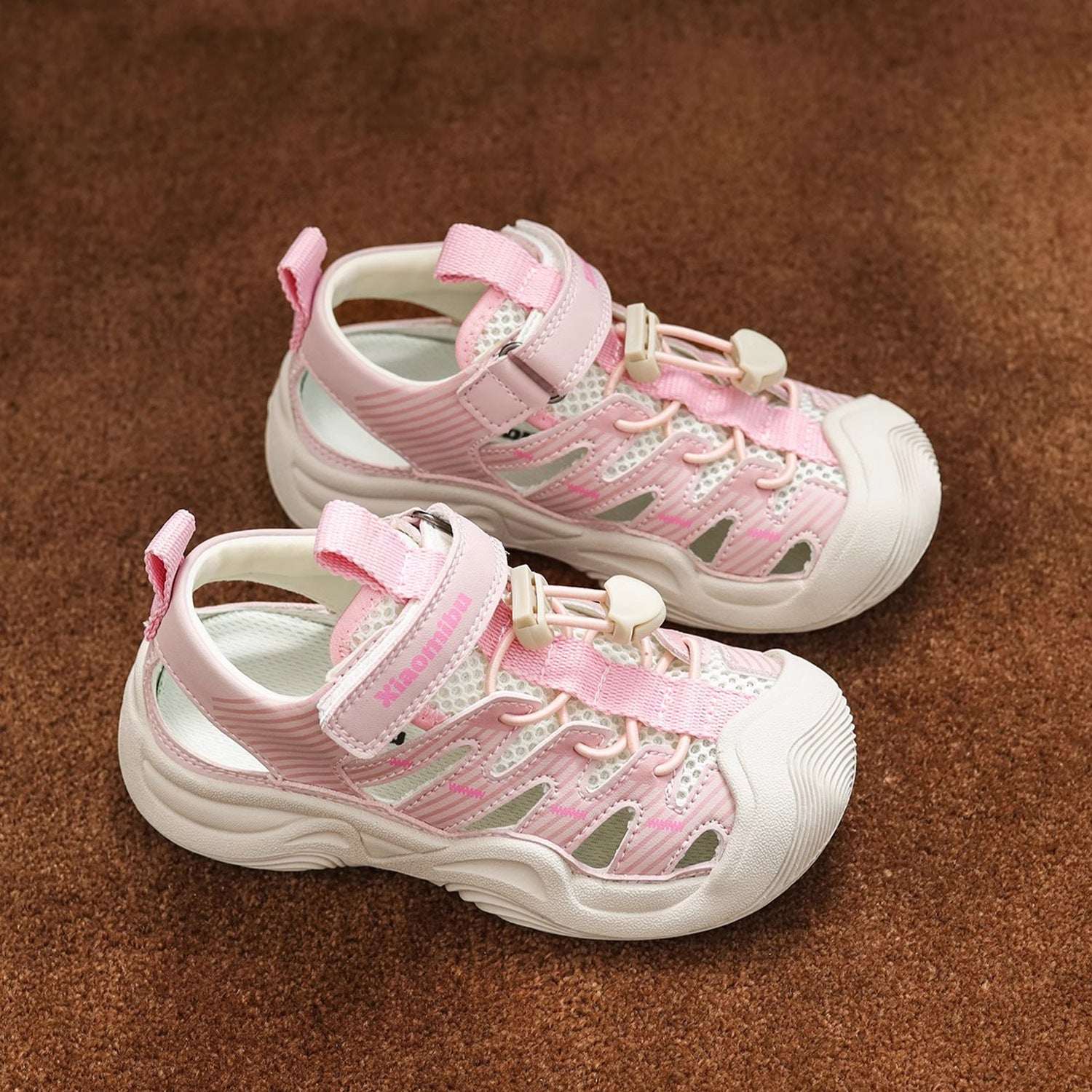 Kids closed-toe sport sandals, pink and white with hook-and-loop strap and cushioned sole