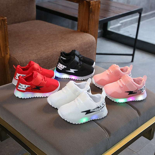 Kids mesh sports shoes set with LED light soles, red black white pink pairs on display