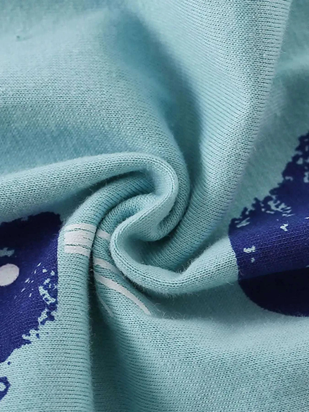 Light blue knit fabric with navy whale print accents