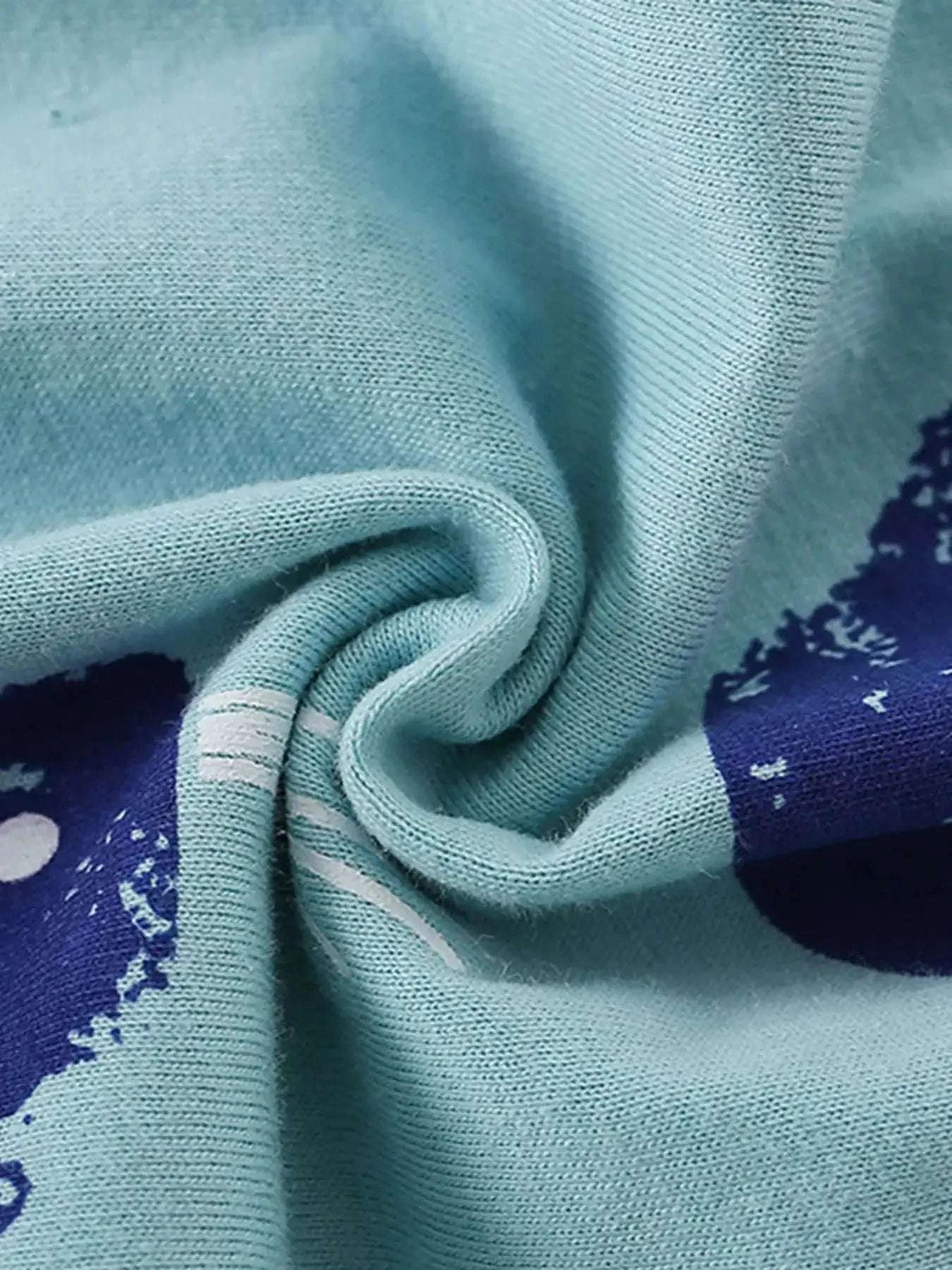 Light blue knit fabric with navy whale print accents