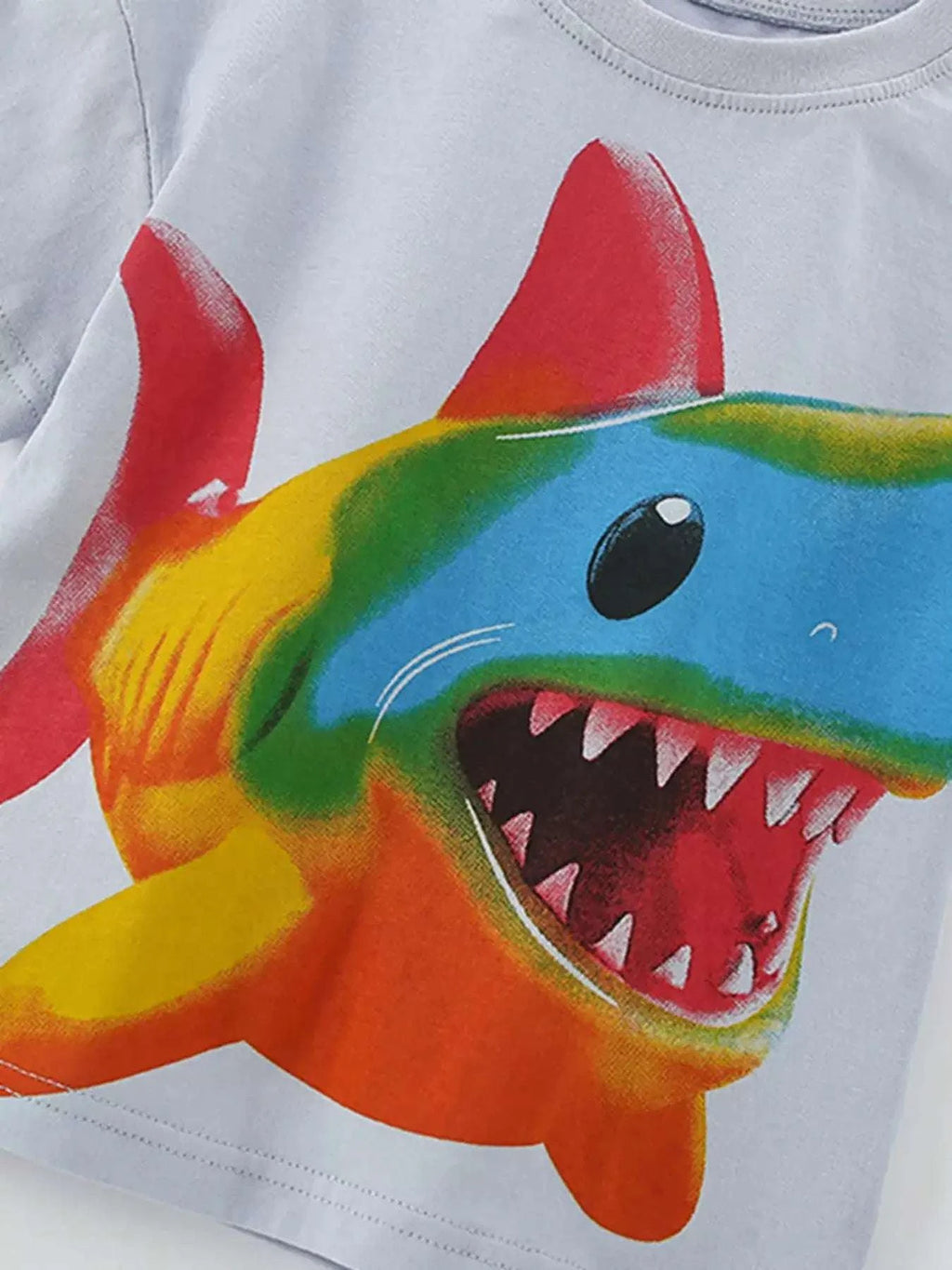 Light gray kids tee with rainbow shark face print and crew neckline