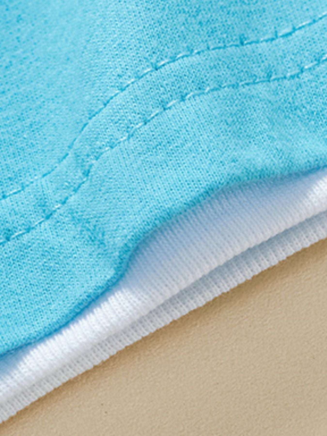 Pastel blue tee with stitched curved hem and white inner facing