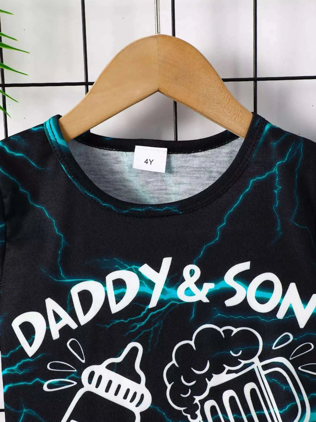 Black lightning print tee with crew neck and white “DADDY & SON” text