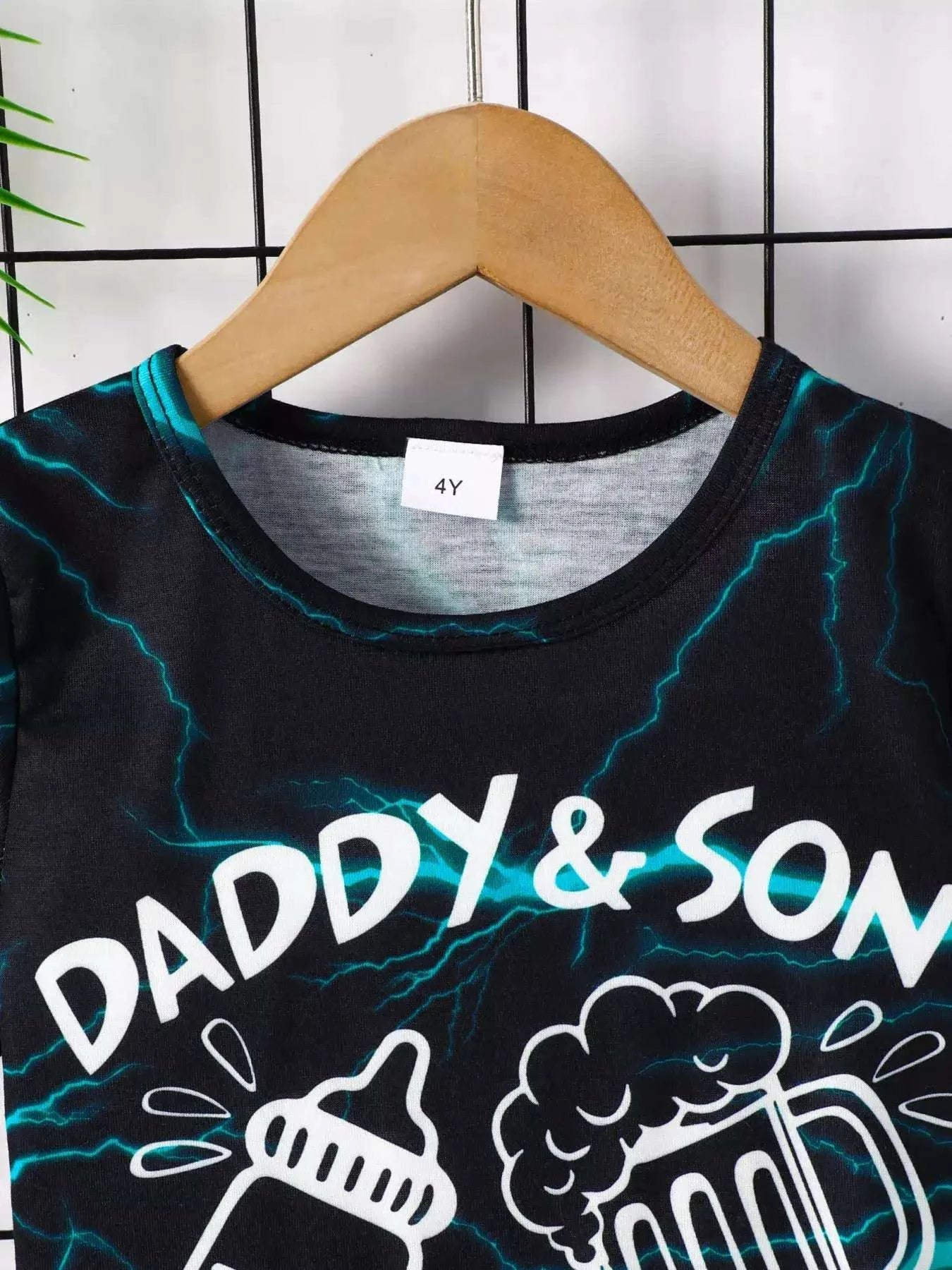 Black lightning print tee with crew neck and white “DADDY & SON” text