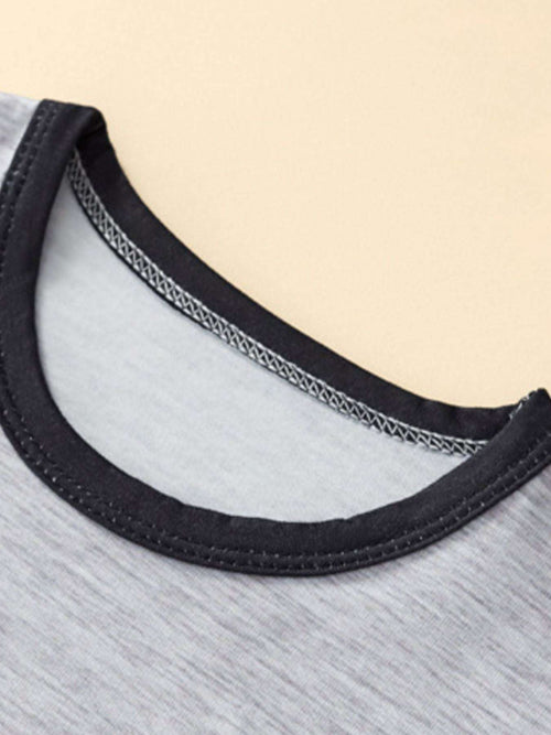 Light gray kids tee neckline with black trim and stitched collar edge