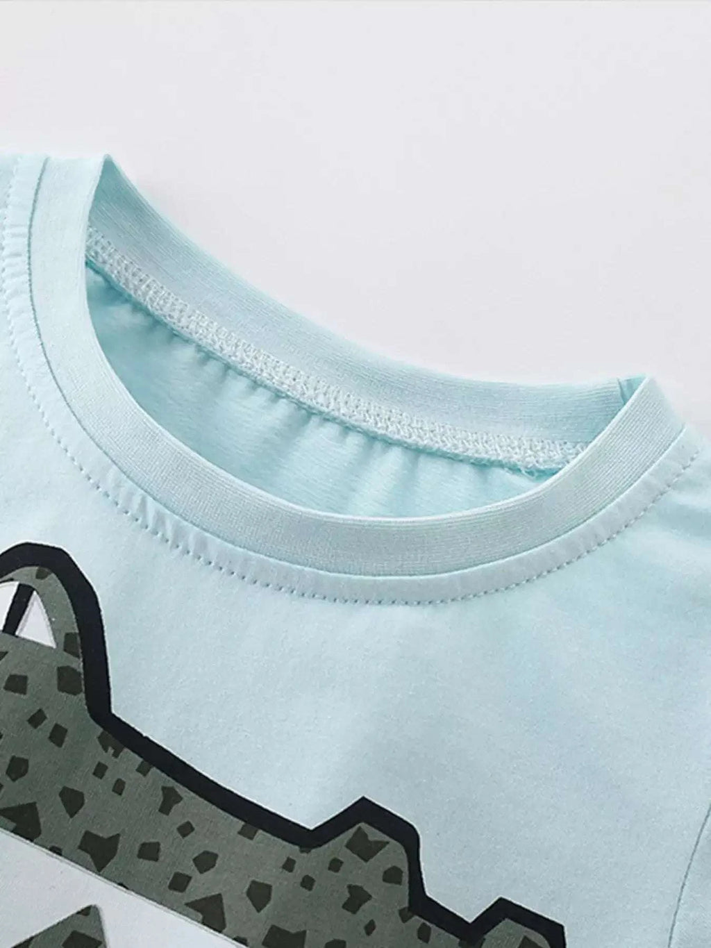 Pastel blue kids' round-neck tee with crocodile graphic trim detail